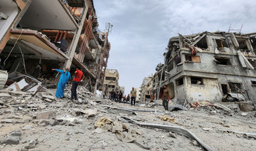 Palestinians inspect the site of an Israeli strike on a house in Beit Lahia, in the northern Gaza Strip. (REUTERS)