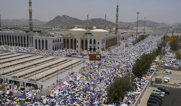 Muslim pilgrims gather outside Nimrah Mosque to offer the noon prayers in Arafat, Saudi Arabia. (AP)